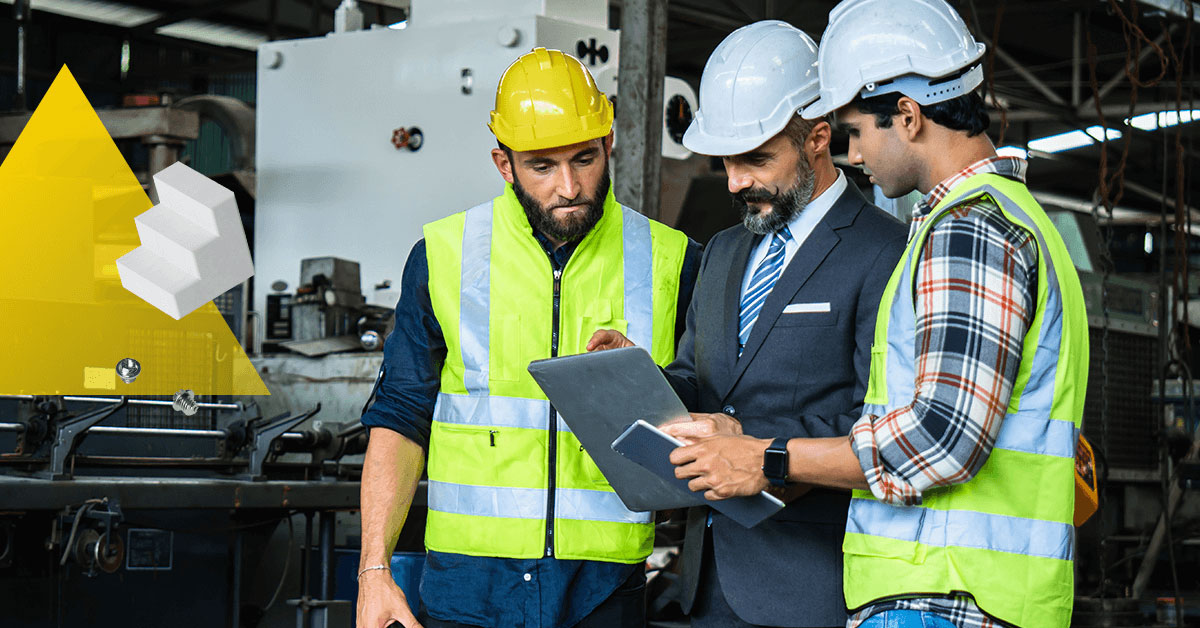 3 manufacturing workers looking at a file